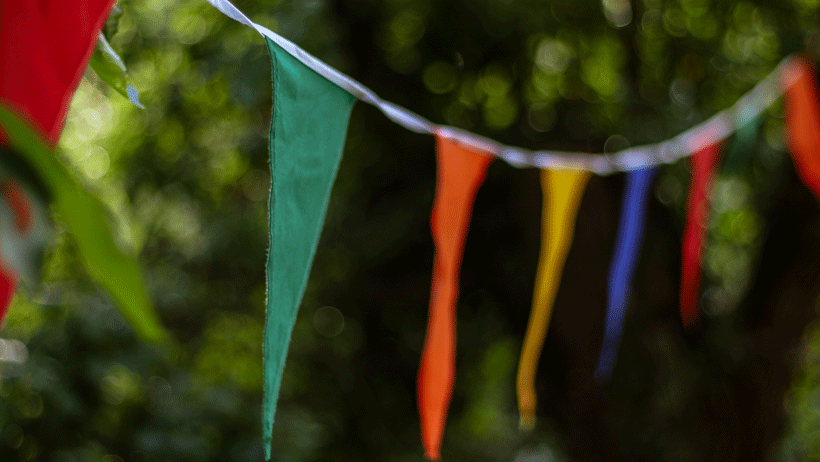 Colourful flags tied to trees