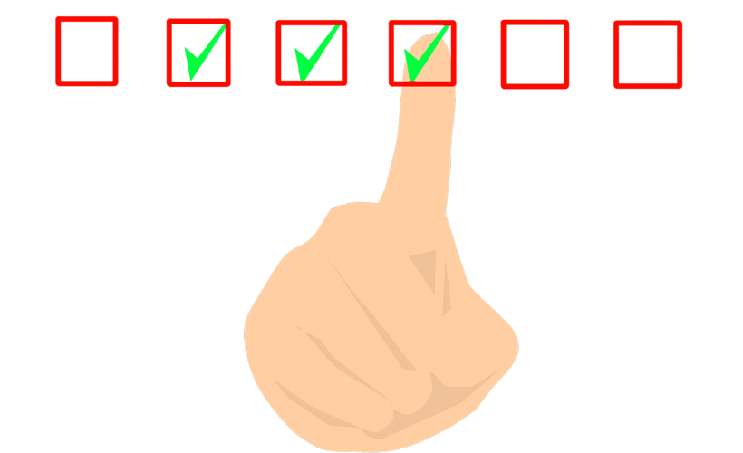 Finger ticking boxes to indicate achievement