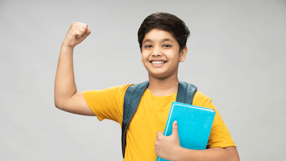 Happy school boy wearing yellow t-shirt flexing arm