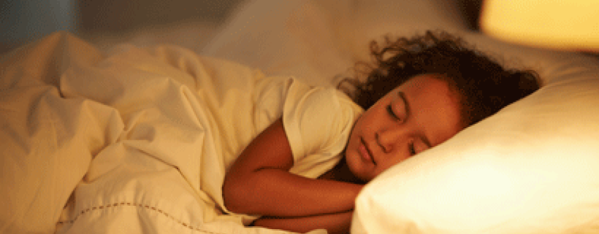 Little girl asleep in bed