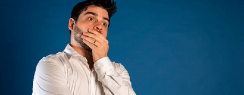 Young male teacher looking anxious and thoughtful against blue background